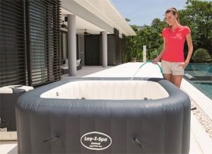 Woman Filling Up the Lay-Z Hawaii Inflatable Hot Tub