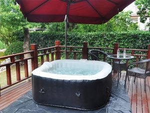 Square Homax Spa on deck under umbrella