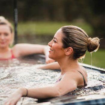 Woman Enjoying Therapeutic Effects of a Salt Water Spa - And How to Convert Your Inflatable Hot Tub to Salt Water